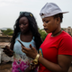 Ami and her friend, also a musician, check their phones after uploading to Instagram on May 22, 2017 in Bamako, Mali.